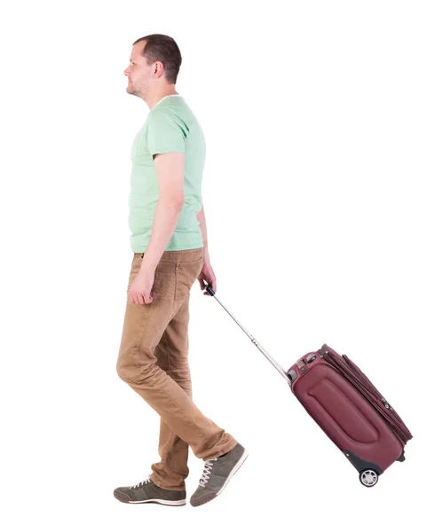 Back view of walking man with suitcase. brunette guy in motio — Stock Photo, Image