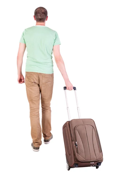 Bakifrån Walking man med resväska. — Stockfoto