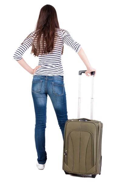 Back view of brunette woman with suitcase looking up — Stock Photo, Image