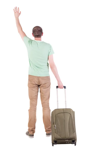 Вид сзади человека с чемоданом. — стоковое фото