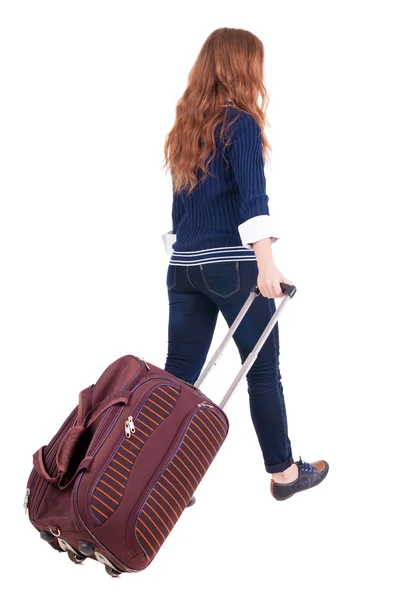 Powrót widok kobieta z walizką — Zdjęcie stockowe