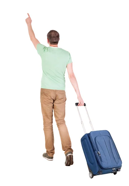 Pohled zezadu na chůzi člověka s kufrem. — Stock fotografie