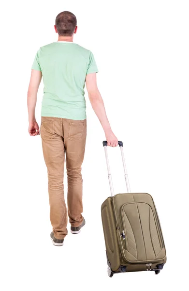 Назад точка зрения идущего человека с чемоданом — стоковое фото