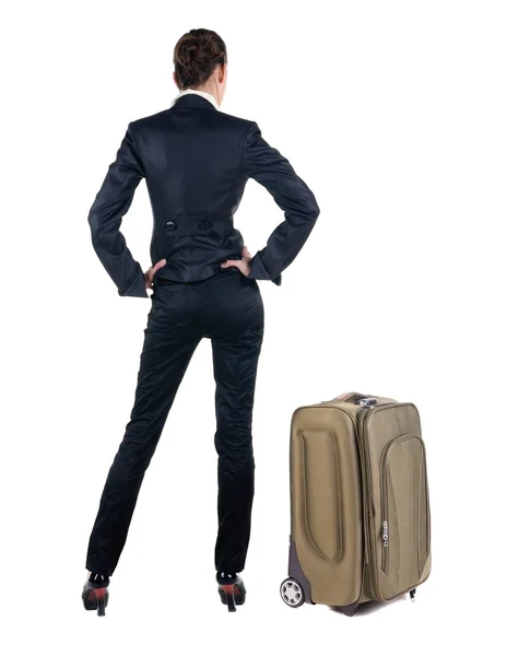 Achteraanzicht van zakenvrouw met koffer — Stockfoto