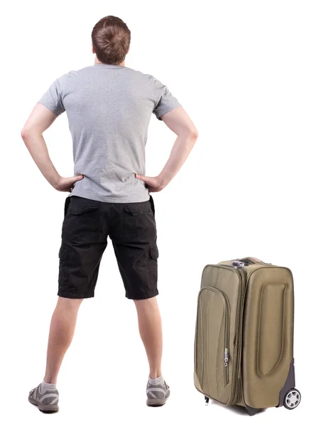 Back view of traveling man with suitcase looking up. — Stock Photo, Image