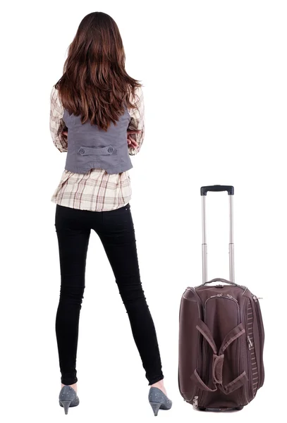 Back view of traveling brunette woman in jeans with suitcase loo — Stock Photo, Image