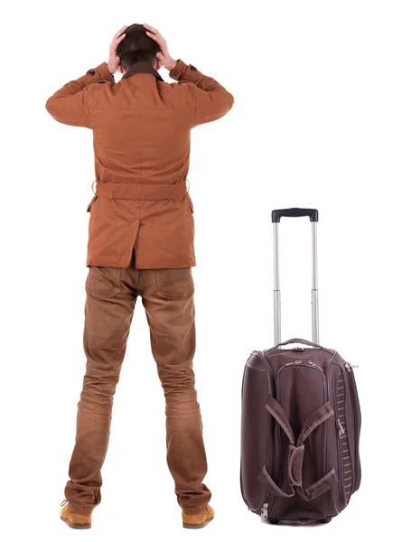 スーツケース探しているとショックを受けたビジネスの男の背面します。. — ストック写真