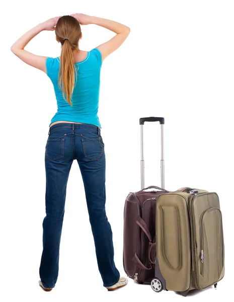Back view of blonde woman with suitcase looking up. — Stock Photo, Image