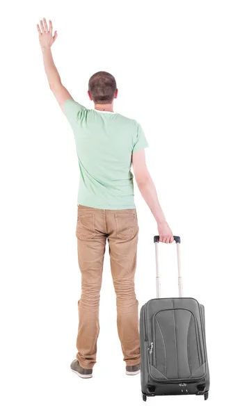 Bakifrån av man med resväska. — Stockfoto