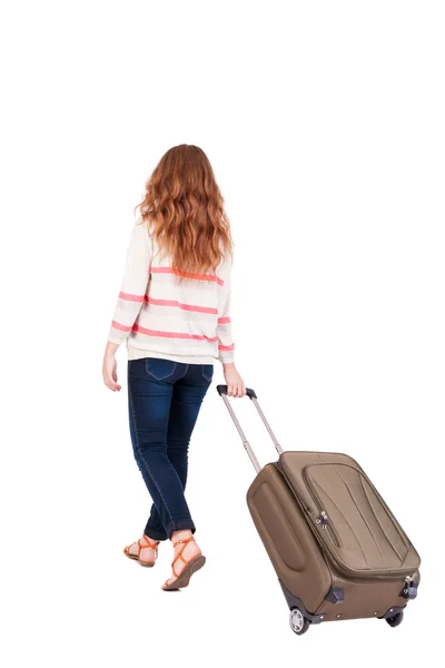 Back view of walking woman with suitcase. — Stock Photo, Image