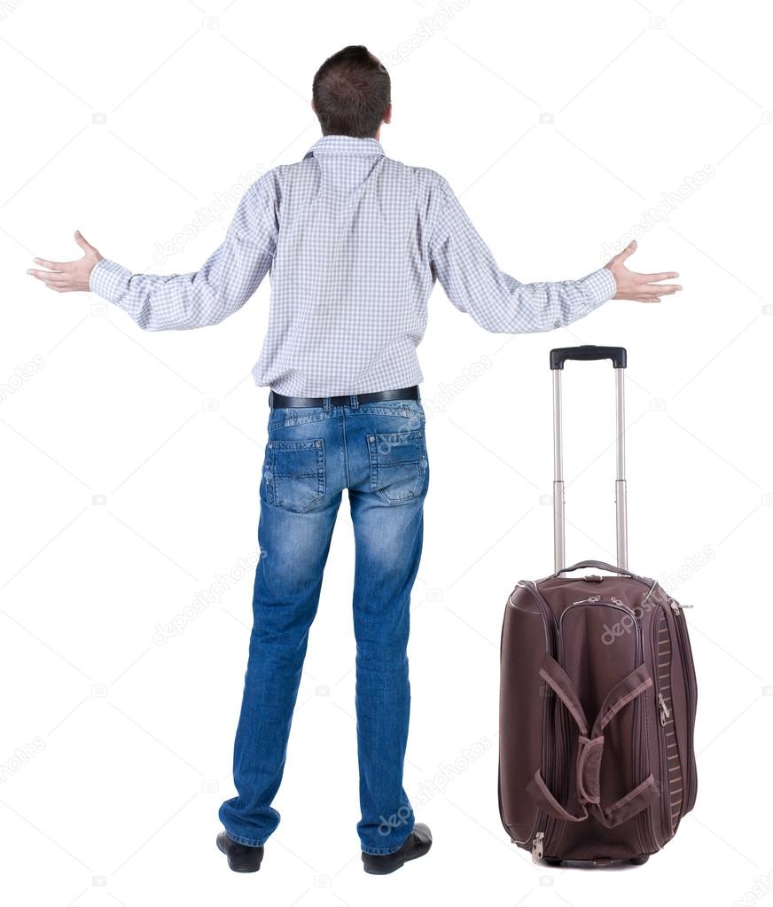 Back view of shocked business man with suitcase looking up.