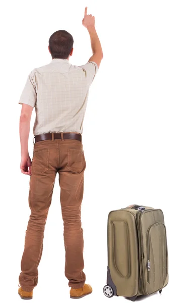 Back view of traveling business man with suitcase pointing. — Stock Photo, Image