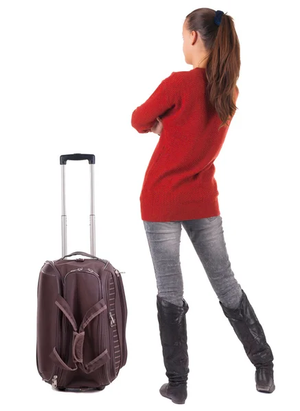 Pohled zezadu na cestování bruneta žena v džínách s kufrem loo — Stock fotografie