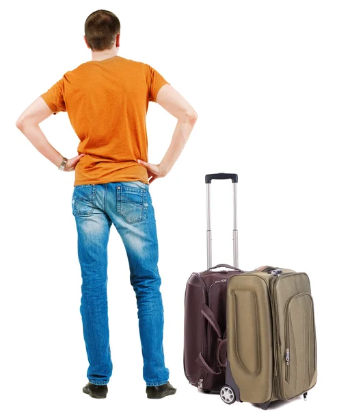 Back view of traveling man with suitcase looking up. — Stock Photo, Image