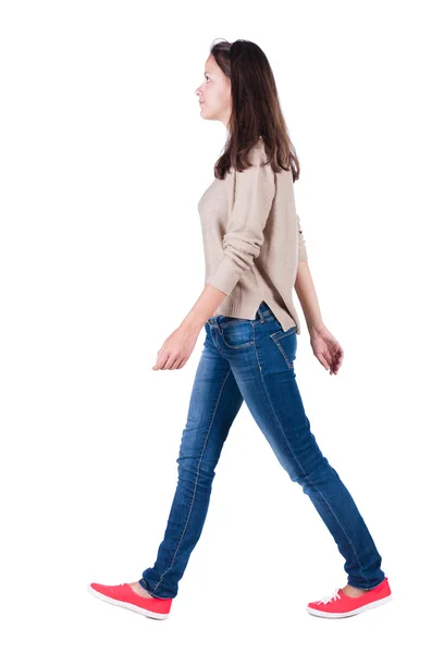 Back view of walking woman in jeans . — Stock Photo, Image