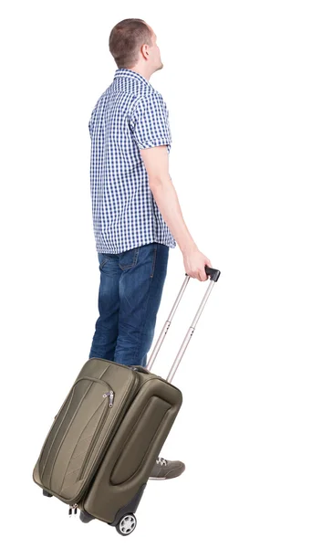緑のスーツケース探している人のコンピューターの背面します。. — ストック写真