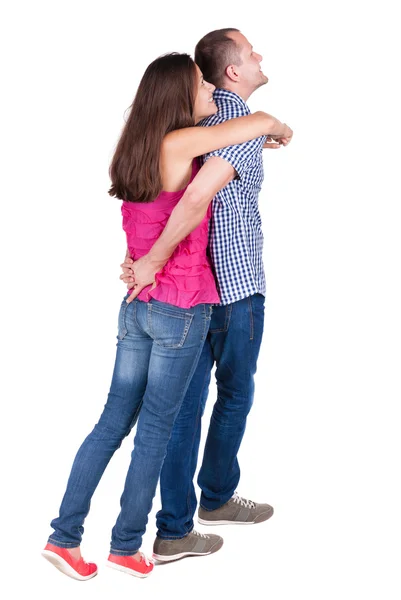 Pareja joven apuntando a la pared atrás vista (hombre y mujer). — Foto de Stock