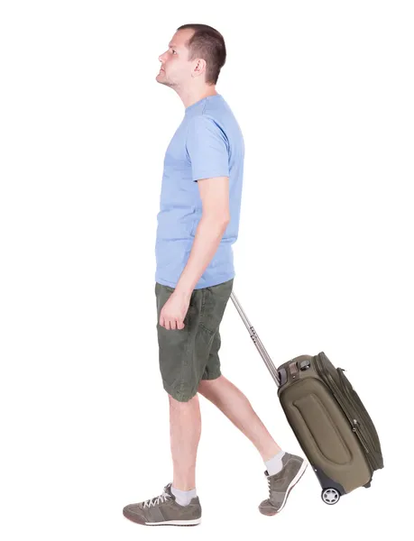 सूटकेस के साथ चलने वाले आदमी का बैक व्यू . — स्टॉक फ़ोटो, इमेज
