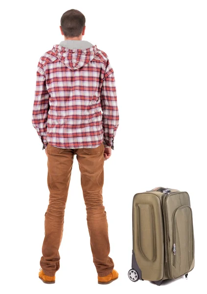 Back view of traveling man with suitcase looking up. — Stock Photo, Image