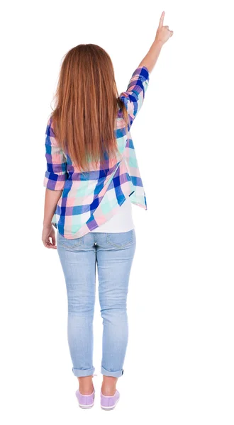 Back view of pointing woman. beautiful redhead girl in jeans. — Stock Photo, Image