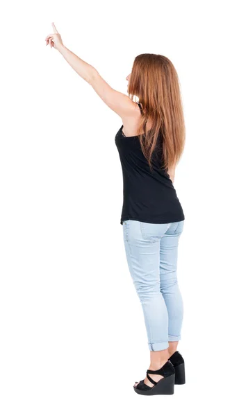 Vista di puntamento donna posteriore. ragazza bella rossa in jeans. — Foto Stock