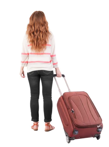 Back view of walking woman with suitcase. — Fotografia de Stock