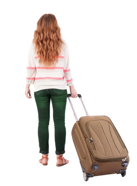 Back view of walking woman with suitcase. — Stock Photo, Image