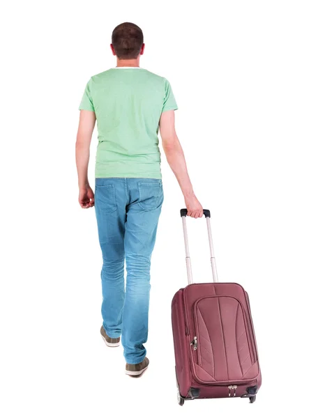 Back view of walking man with suitcase. — Stock Photo, Image