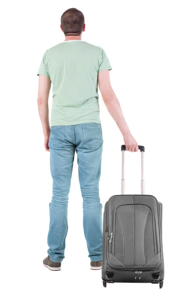 Bakifrån av man med resväska tittar upp — Stockfoto