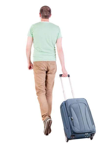 Powrót widok zwiedzanie człowiek z walizką. — Zdjęcie stockowe