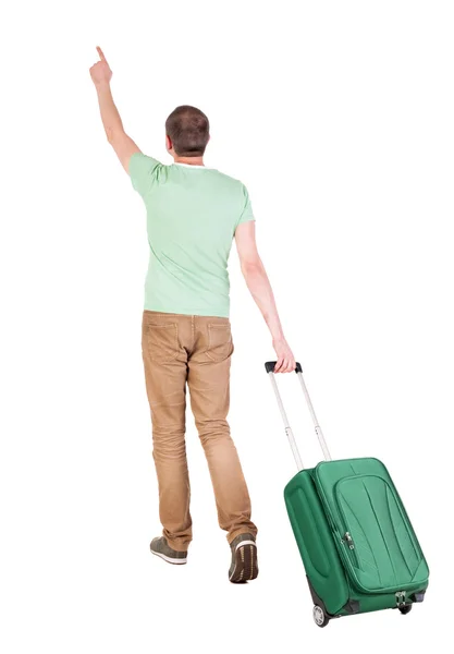 Pohled zezadu na chůzi člověka s kufrem. — Stock fotografie