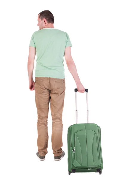 Bakifrån av man med resväska tittar upp — Stockfoto