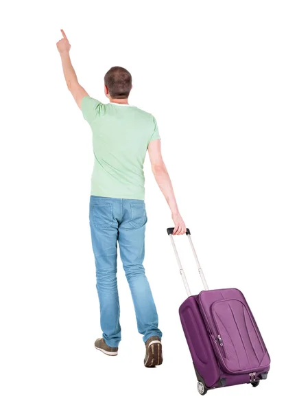 Назад точка зрения идущего человека с чемоданом. — стоковое фото