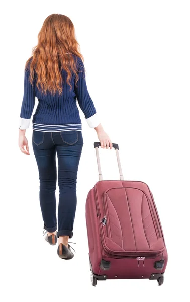 Back view of walking woman with suitcase — Stock Photo, Image