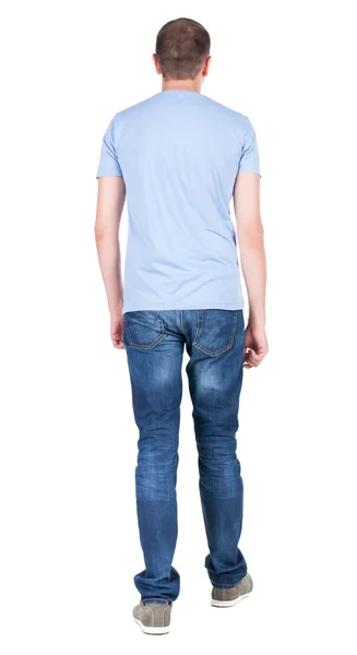 Vista posterior de joven con camiseta y pantalones vaqueros mirando. tipo standi — Foto de Stock