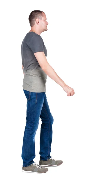 Rückansicht eines gutaussehenden Mannes in Jeans und Hemd. — Stockfoto