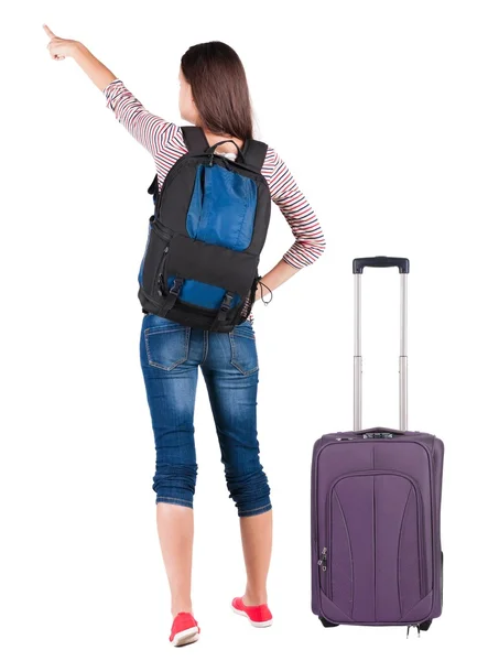 Back view of pointing woman with backpack looking up. — Stock Photo, Image