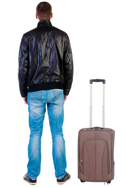 Vista posterior de viajar hombre guapo en chaqueta con mirada suitcas —  Fotos de Stock