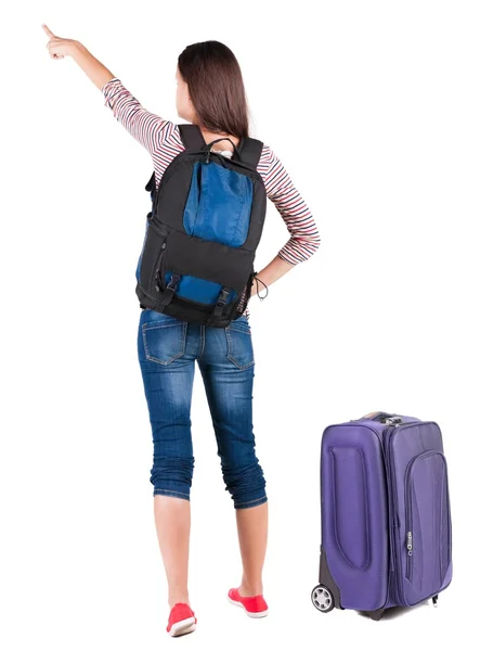 Rückansicht des Zeigegeräts Frau mit Rucksack nachschlagen. — Stockfoto