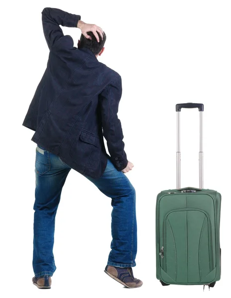Young traveling expert with suitcas looks ahead — Stock Photo, Image
