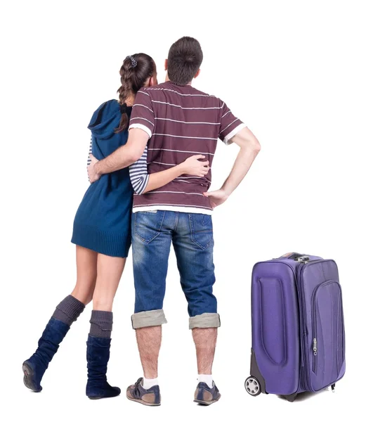 Young traveling couple with suitcas looks where that. — Stock Photo, Image