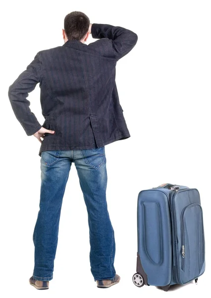 Young traveling expert with suitcas looks ahead — Stock Photo, Image
