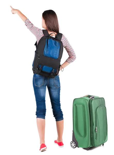 Back view of pointing woman with backpack looking up. — Stock Photo, Image