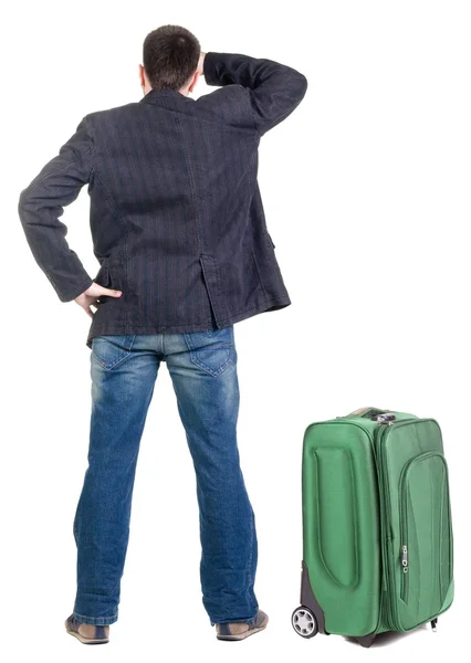 Young traveling expert with suitcase looks ahead — Stock Photo, Image