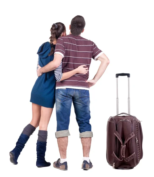 Mladý cestující pár s suitcas vypadá kde to. — Stock fotografie