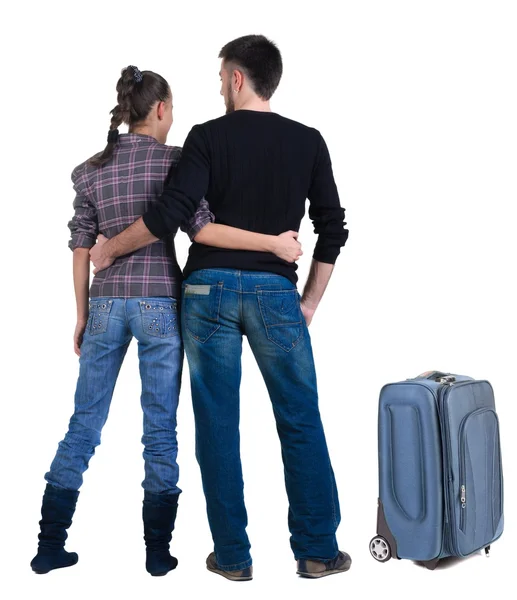 Young traveling couple with suitcas looks where that — Stock Photo, Image