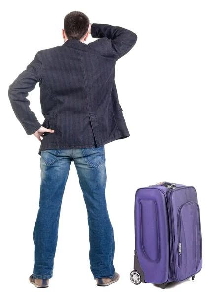 Young traveling expert with suitcas looks ahead — Stock Photo, Image