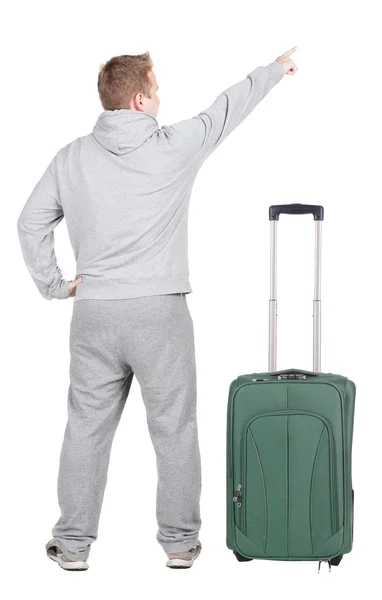 Pointing young men traveling with suitcas — Stock Photo, Image