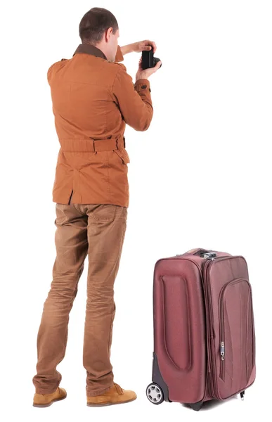 Uomo fotografare viaggiando con valigia — Foto Stock