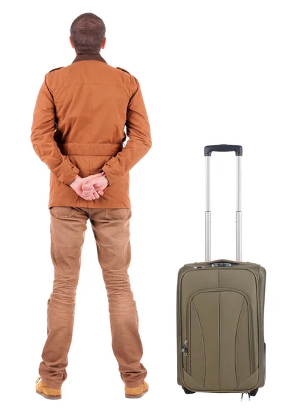 Back view of young man traveling with suitcas. — Stock Photo, Image